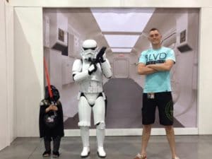 Daniel Artt with his daughter in Darth Vader costume next to stormtrooper statue